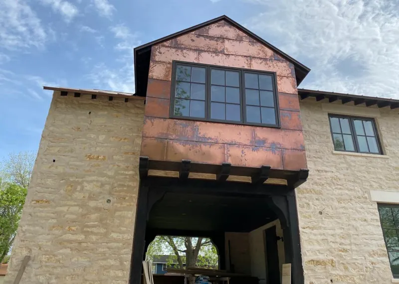 Copper metal panel facade on a stone building for Skylight Installation in Ramona